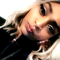 Stylish Satasha, a Young Adult, Showcasing her Tattoo and Sparkling Eyes