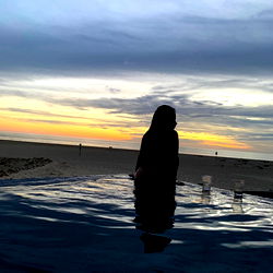 Beach at Sunset with Reflection of Person in Pool