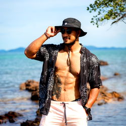 Fit and Tanned Model Strikes Pose on Beach