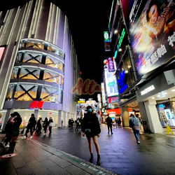 Nighttime Cityscape at Alta, with People Walking on Sidewalk