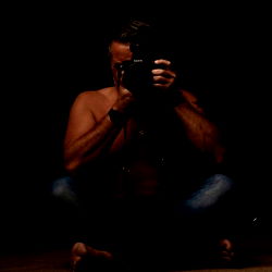 Photographer in Sitting Pose with Camera