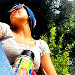 Chic Outdoor Girl Sips on a Colorful Flask