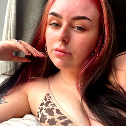 Young Adult Woman with Pink Hair and Tattoos