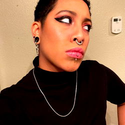 Lover Boi with Unique Earrings and Stylish Tattoos