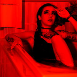 Red-Tinted Model Photo with Onlyfans Overlay