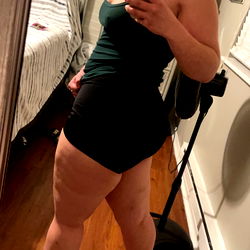 Fitness Model Showcasing Her Body in a Home Gym