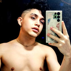 Davidanuel69, a Colombian OnlyFans Model Showcasing his Muscular Physique in an Unbuttoned Shirt with Tattoos and Piercing