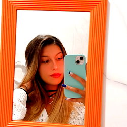 Model in an Orange Frame Mirror with Light Blue Background
