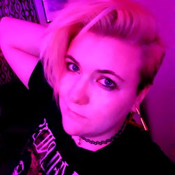 A Young Man with Short Blonde Hair, Smiling at the Camera