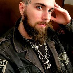 Bearded Man in Sunglasses, Black Jacket and Necklace