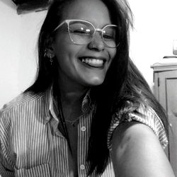 Smiling woman in a striped shirt and glasses