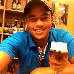 Alex Black posing with beer and smiling