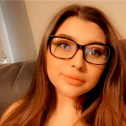 Woman Wearing Glasses and Sitting on a Couch