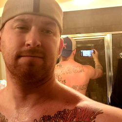 A Man in a Bathroom Mirror