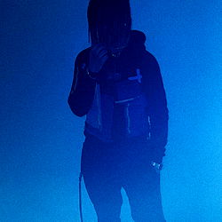 Stylish Fashion Model Against a Neon Blue Background