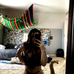 A Model Posing in a Bedroom