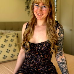Young Woman with Tattoos, Glasses and Floral Dress