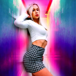 Emilia Parris, OnlyFans Model, Posing for a Colorful Photo in a Nightclub-like Setting