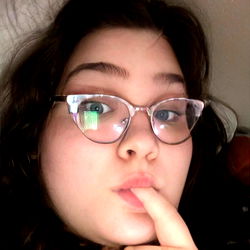 Female with Glasses and Finger on Her Lip