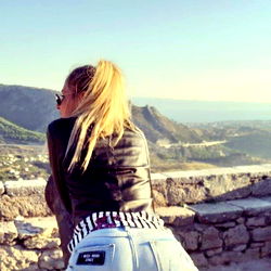 Enjoying a scenic view from atop a stone wall in Croatia