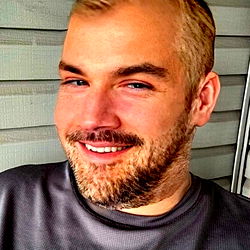 Bearded Man in Grey Shirt with Smile