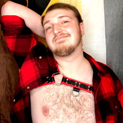 The Cinema Bear, a young man from Florida, posing shirtless and confident with his hands on his hips.