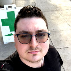 Casually Styled Man in Sunglasses on a Street