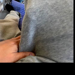 Person sitting in front of a laptop screen with their feet on the table