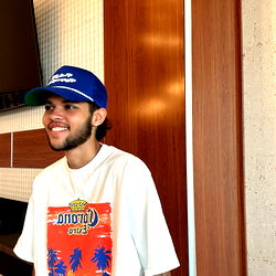 Casual Male Model in a Tropical Print Shirt and Blue Cap