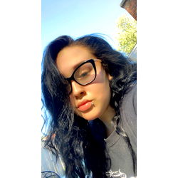 Woman in Black Glasses Smiling at the Camera