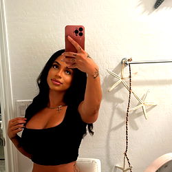 Model taking a selfie in bathroom mirror