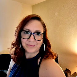 Young Woman with Glasses Smiling at Camera