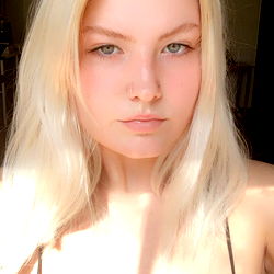 Selina, a beautiful woman with blonde hair and blue eyes.