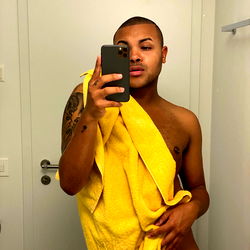 OnlyFans Model Kevin Poses in Shower, Yellow Towel Draped Over Shoulder