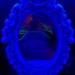 Vividly Lit Vanity Mirror in a Room with Blue Lighting