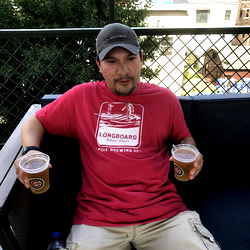 A Man Enjoying His Beer at a Rooftop Bar