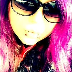 Brandy, a vibrant model with pink hair and sunglasses, captured in a candid moment. Tags: #modelphotography #onlyfans #vibrantcolor #pinkhair #sunglasses. Age: 25.