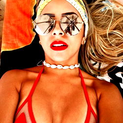 Fashionable Model in Red Swimsuit Striking a Pose on Beach