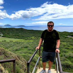 Adventurous Accountant in Hawaii, Standing on a Walkway with the Ocean View