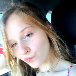 Young Female Smiling for the Camera in a Car