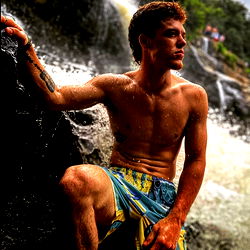 Shirtless Outdoor Model with Tattoo, Leaning on Rock