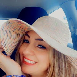 Woman in a Stylish Hat, Smiling at the Camera