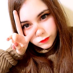 Ashiko, a young woman striking a pose with her hand on her face, making a peace sign