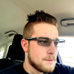 Young Adult Male with Short Hair, Glasses and a Tattoo