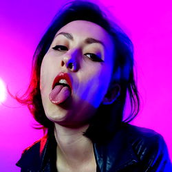 Edgy Female Model with a Striking Tongue