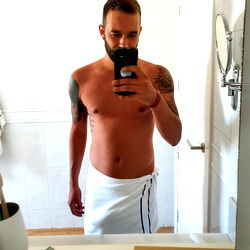 A Man Taking a Mirror Selfie in the Bathroom