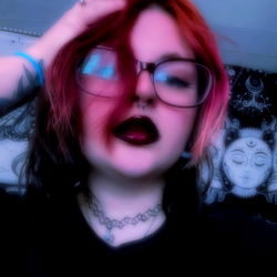 Gothic Emo Girl with Red Hair and Heavy Eye Makeup