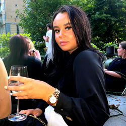 Social Media Influencer at Outdoor Event, Enjoying Wine