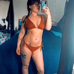 A Stylish OnlyFans Model in a Bathing Suit Poses for a Photo