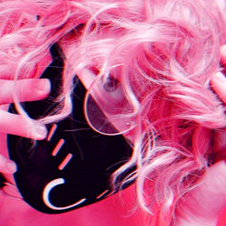 OnlyFans Model Anymuun69 with Pink Hair and Black Mask in a Playful Mood